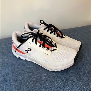 On Running White Sneakers with Orange and Black Accents